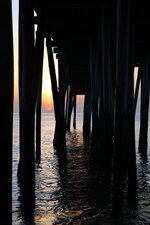 Sunset Beneath the Pier Pilings