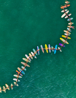 Surfers Holding Hands